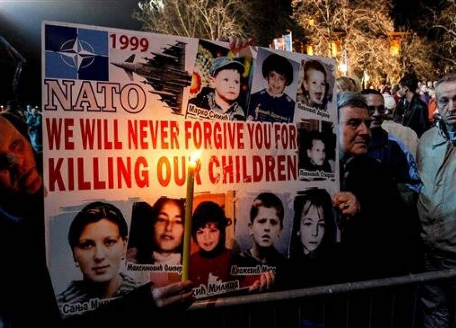 Protesto anti-OTAN, que ocorreu na Servia. O Cartaz diz “OTAN, nós nunca vamos perdoa-los pelo assassinato de nossas crianças.”